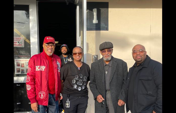  church members standing outside of school with Mrs. Denard and Mr. Wilson